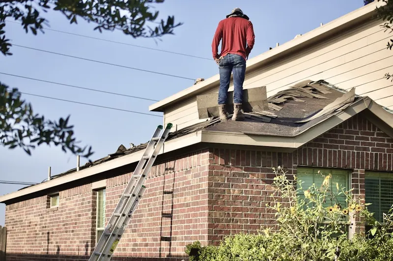 Professional roofer working on a residential roof in Chevy Chase Section Three